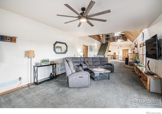 39445 Main St, Eaton, CO 80615 - living room featuring ceiling fan, stairway, vaulted ceiling, and carpet floors