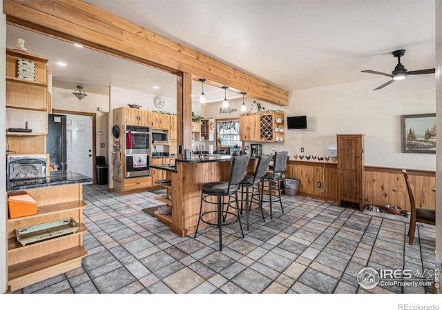 39445 Main St, Eaton, CO 80615 - kitchen featuring open shelves, appliances with stainless steel finishes, dark countertops, beam ceiling, and wainscoting