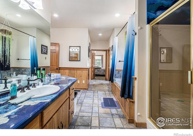 39445 Main St, Eaton, CO 80615 - ensuite bathroom with a wainscoted wall, vanity, a shower stall, stone finish flooring, and wooden walls