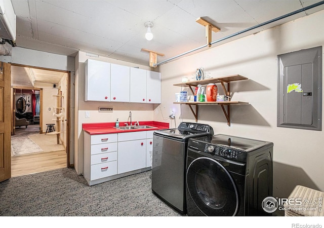 39445 Main St, Eaton, CO 80615 - laundry area featuring independent washer and dryer, electric panel, and cabinet space