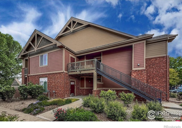 804 Summer Hawk Dr Unit 105, Longmont, CO 80504 - view of front of home with brick siding and stairs