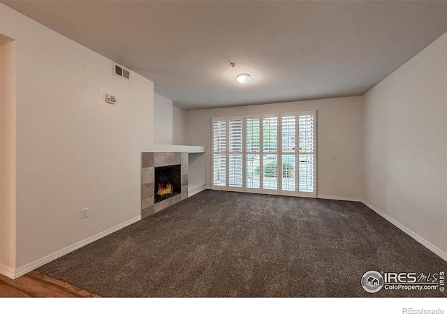 804 Summer Hawk Dr Unit 105, Longmont, CO 80504 - unfurnished living room featuring a fireplace, baseboards, and carpet