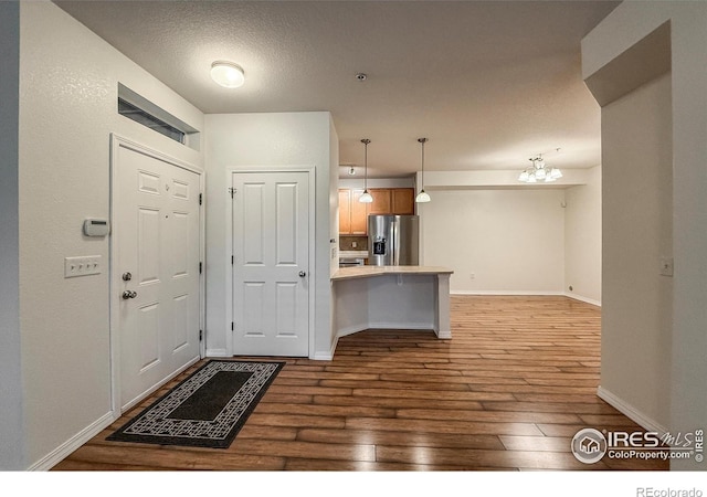 804 Summer Hawk Dr Unit 105, Longmont, CO 80504 - entryway with wood-type flooring, a chandelier, and baseboards