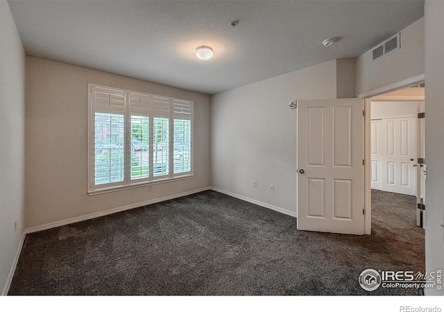 804 Summer Hawk Dr Unit 105, Longmont, CO 80504 - unfurnished room with dark carpet, baseboards, and a pendent fire sprinkler