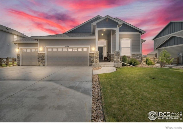 1368 Waterfall St, Timnath, CO 80547 - craftsman inspired home featuring stone siding, an attached garage, driveway, and a front lawn