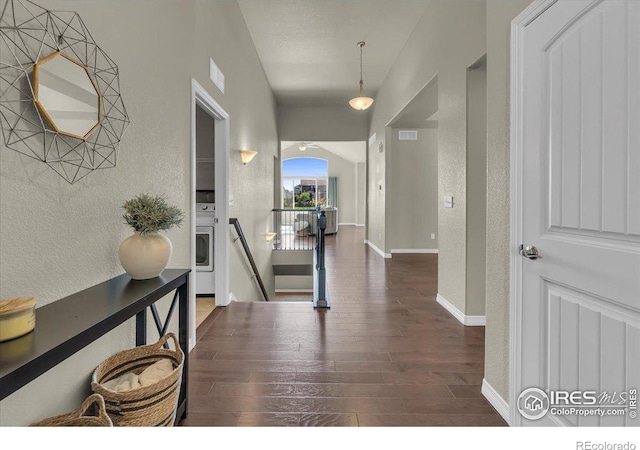 1368 Waterfall St, Timnath, CO 80547 - hall featuring an upstairs landing, wood finished floors, a textured wall, baseboards, and washer / dryer