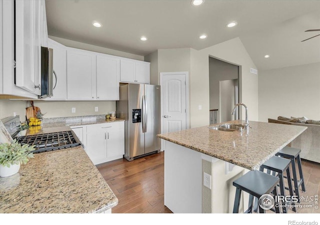 1368 Waterfall St, Timnath, CO 80547 - kitchen featuring stainless steel fridge with ice dispenser, gas stove, dark wood-style floors, light stone counters, and recessed lighting