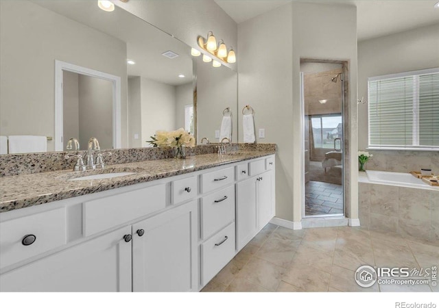 1368 Waterfall St, Timnath, CO 80547 - full bathroom with double vanity, a bath, a stall shower, and baseboards
