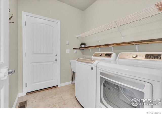 1368 Waterfall St, Timnath, CO 80547 - laundry room with washer and clothes dryer and baseboards
