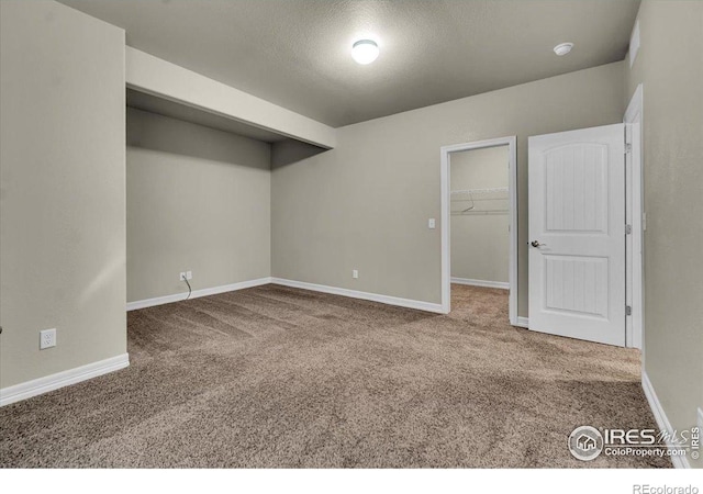 1368 Waterfall St, Timnath, CO 80547 - below grade area featuring carpet, baseboards, and a textured ceiling