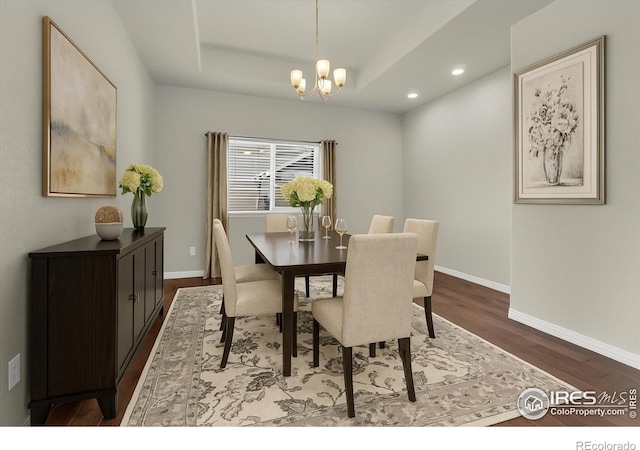 1368 Waterfall St, Timnath, CO 80547 - dining area with wood finished floors, a chandelier, recessed lighting, and a raised ceiling