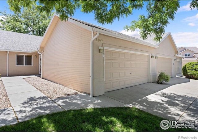 3641 Wild Horse Ct, Loveland, CO 80538 - garage featuring concrete driveway
