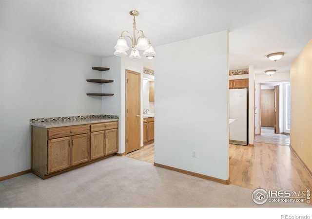 3641 Wild Horse Ct, Loveland, CO 80538 - unfurnished dining area with a chandelier, baseboards, and light wood-style flooring