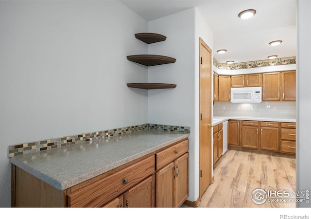 3641 Wild Horse Ct, Loveland, CO 80538 - kitchen featuring white microwave, decorative backsplash, light wood finished floors, brown cabinetry, and open shelves