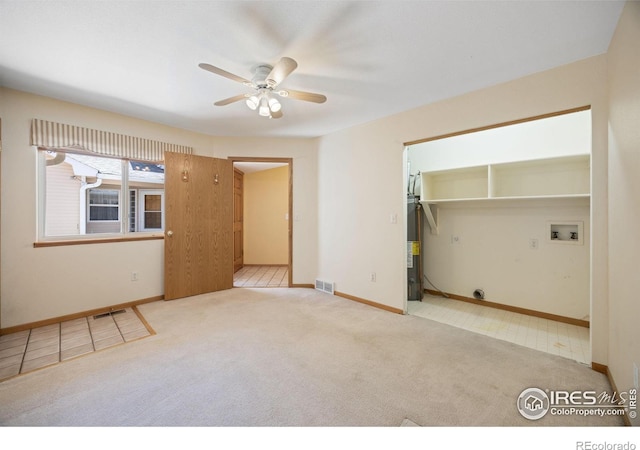 3641 Wild Horse Ct, Loveland, CO 80538 - spare room featuring carpet, gas water heater, ceiling fan, and baseboards