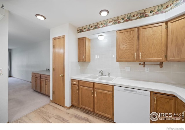 3641 Wild Horse Ct, Loveland, CO 80538 - kitchen with dishwasher, a sink, decorative backsplash, light wood-style flooring, and light countertops