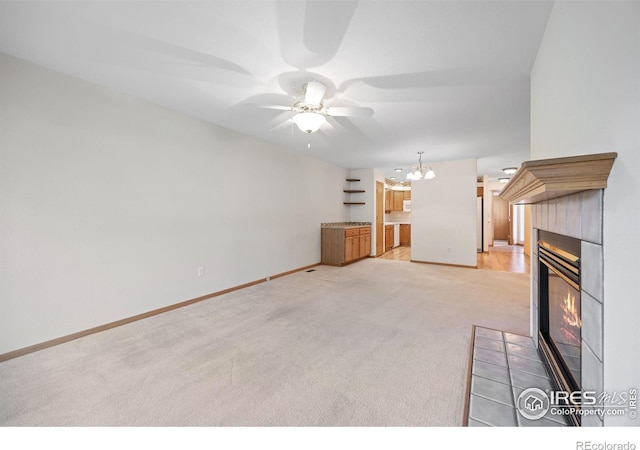 3641 Wild Horse Ct, Loveland, CO 80538 - unfurnished living room featuring light colored carpet, a fireplace, a ceiling fan, a chandelier, and baseboards