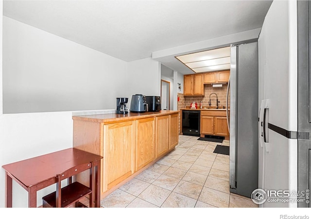 928 Michael Ave, Fort Morgan, CO 80701 - kitchen with dishwasher, backsplash, a sink, light tile patterned floors, and freestanding refrigerator