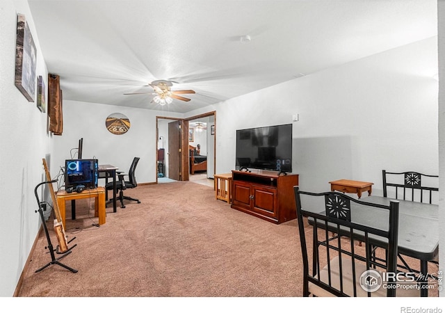 928 Michael Ave, Fort Morgan, CO 80701 - living room with light colored carpet, a ceiling fan, a desk, and baseboards