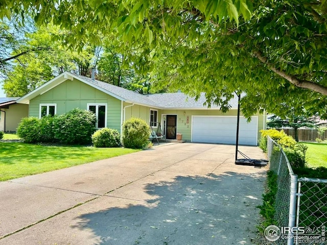 1722 Pheasant Rdg, Sterling, CO 80751 - ranch-style house featuring board and batten siding, an attached garage, and concrete driveway