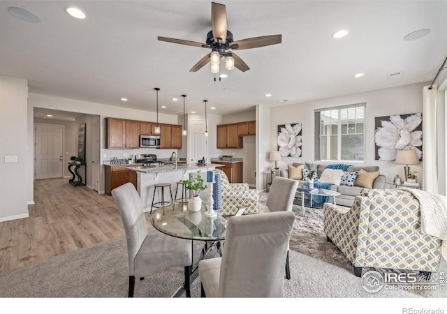 17871 E 96th Pl, Commerce City, CO 80022 - dining space featuring recessed lighting, light wood-type flooring, a ceiling fan, and baseboards