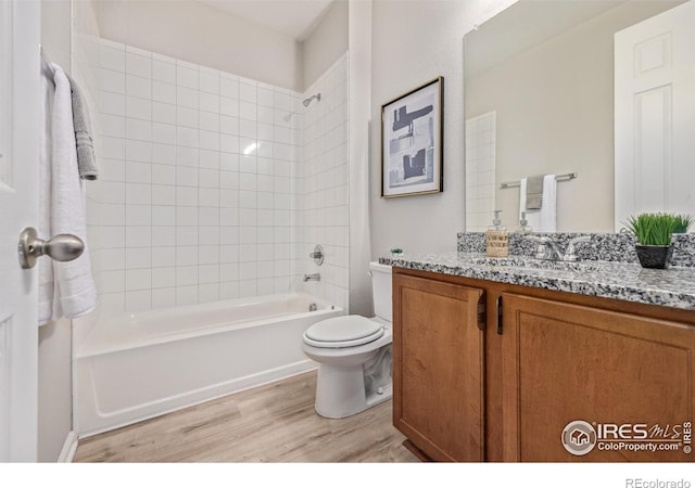 17871 E 96th Pl, Commerce City, CO 80022 - bathroom with wood finished floors, vanity, shower / washtub combination, and toilet