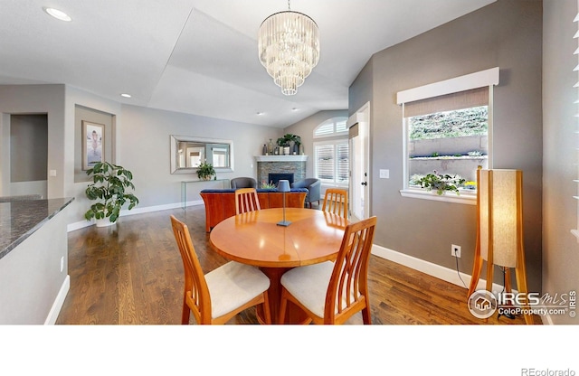 6945 N Fargo Trl, Littleton, CO 80125 - dining room with a fireplace, wood finished floors, recessed lighting, and a chandelier