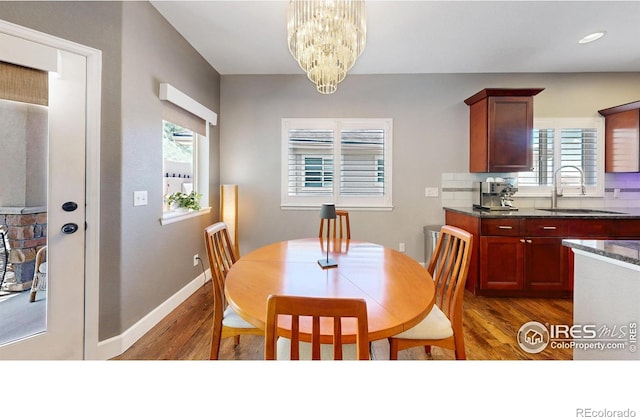 6945 N Fargo Trl, Littleton, CO 80125 - dining area featuring dark wood-type flooring and a chandelier
