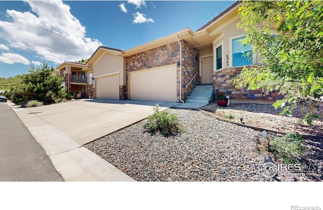 6945 N Fargo Trl, Littleton, CO 80125 - view of front facade with a garage, concrete driveway, and stone siding