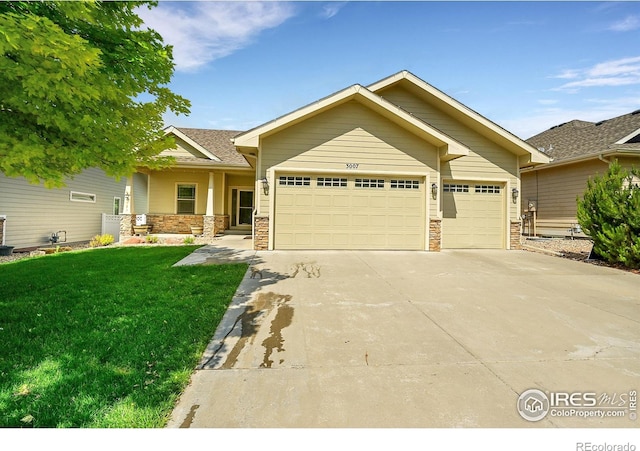 3007 68th Ave, Greeley, CO 80634 - craftsman inspired home with an attached garage, a front lawn, driveway, and stone siding