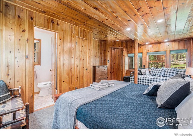 6600 State Highway 7, Estes Park, CO 80517 - carpeted bedroom with wood ceiling, wooden walls, recessed lighting, and ensuite bath
