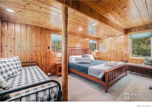 6600 State Highway 7, Estes Park, CO 80517 - carpeted bedroom with wooden ceiling, multiple windows, wood walls, and recessed lighting