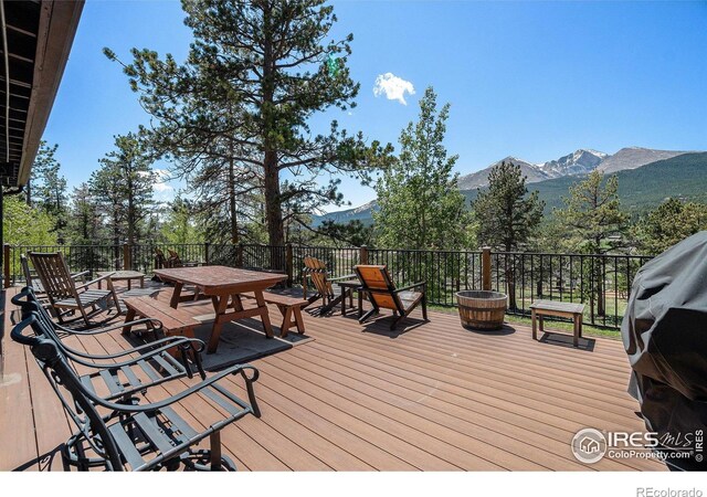 6600 State Highway 7, Estes Park, CO 80517 - wooden deck with a mountain view and outdoor dining area