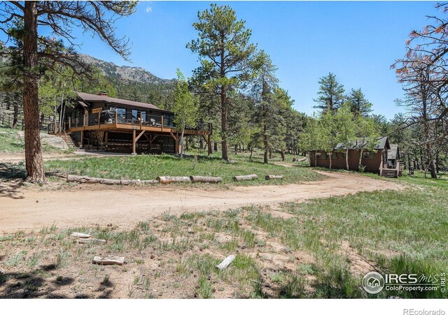 6600 State Highway 7, Estes Park, CO 80517 - view of yard with a deck with mountain view