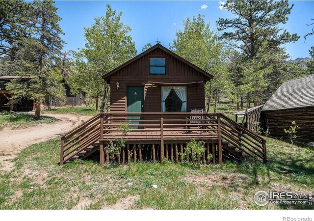 6600 State Highway 7, Estes Park, CO 80517 - view of front of home with stairway, a wooden deck, and board and batten siding