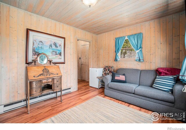 6600 State Highway 7, Estes Park, CO 80517 - living area with wooden ceiling, baseboard heating, wood walls, and wood finished floors