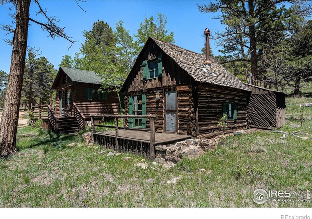 6600 State Highway 7, Estes Park, CO 80517 - back of property featuring a wooden deck, an outbuilding, and log exterior