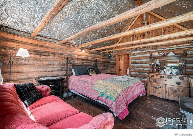 6600 State Highway 7, Estes Park, CO 80517 - bedroom featuring log walls, hardwood / wood-style flooring, and vaulted ceiling