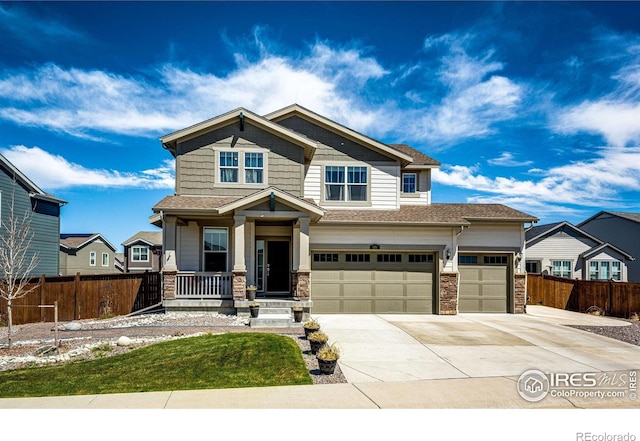 1191 Horsetail Loop, Elizabeth, CO 80107 - craftsman inspired home featuring driveway, stone siding, covered porch, an attached garage, and roof with shingles