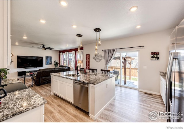 1191 Horsetail Loop, Elizabeth, CO 80107 - kitchen featuring appliances with stainless steel finishes, a sink, white cabinetry, ceiling fan, and light wood-style floors