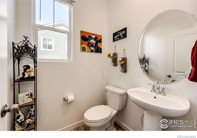 1191 Horsetail Loop, Elizabeth, CO 80107 - half bath featuring baseboards, toilet, and wood finished floors