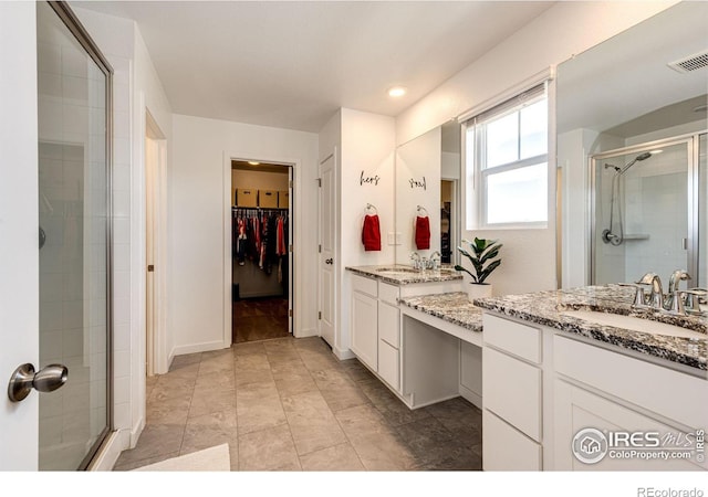1191 Horsetail Loop, Elizabeth, CO 80107 - full bath featuring a stall shower, two vanities, and a walk in closet