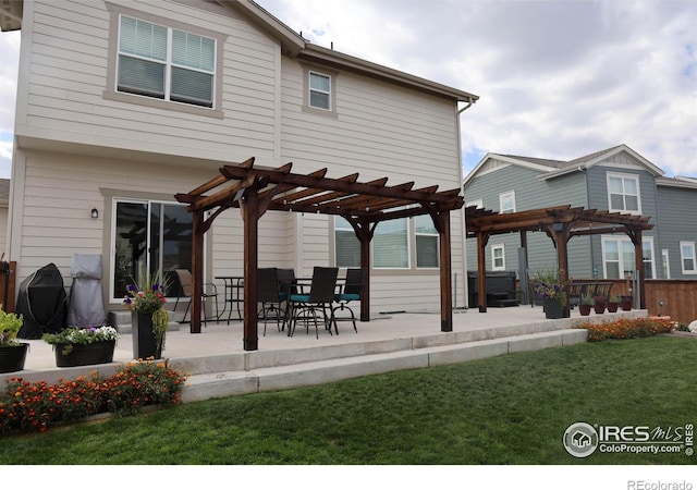 1191 Horsetail Loop, Elizabeth, CO 80107 - rear view of house featuring a pergola, a lawn, and a patio area