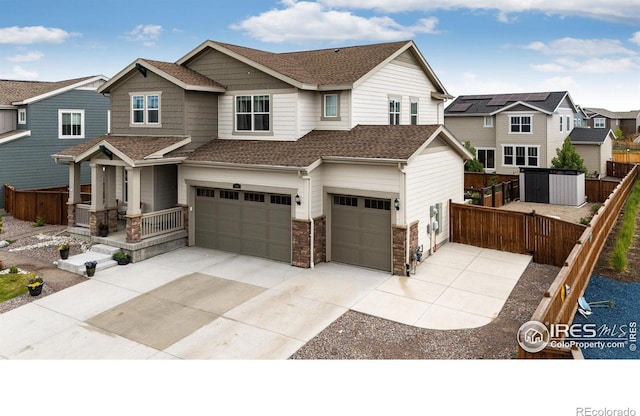 1191 Horsetail Loop, Elizabeth, CO 80107 - view of front of home featuring a garage, roof with shingles, driveway, stone siding, and a residential view