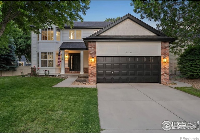 10216 Sandy Ridge Ct, Firestone, CO 80504 - view of front of home featuring a garage, concrete driveway, and brick siding