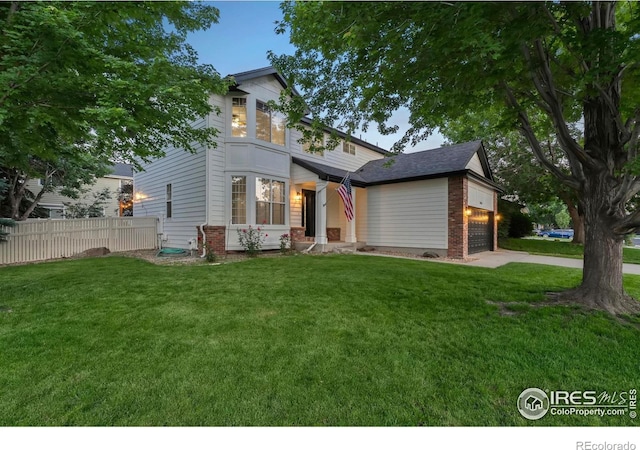 10216 Sandy Ridge Ct, Firestone, CO 80504 - view of front facade featuring an attached garage, brick siding, and driveway