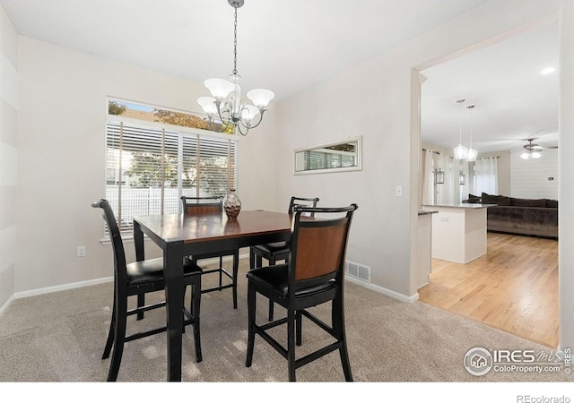 10216 Sandy Ridge Ct, Firestone, CO 80504 - dining space featuring a chandelier, baseboards, light carpet, and a ceiling fan