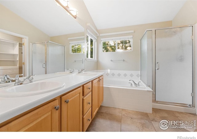 10216 Sandy Ridge Ct, Firestone, CO 80504 - bathroom featuring a shower stall, double vanity, lofted ceiling, a bath, and tile patterned floors
