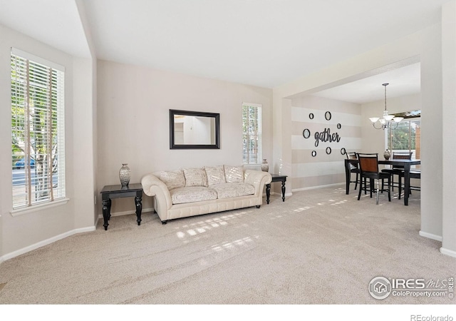 10216 Sandy Ridge Ct, Firestone, CO 80504 - carpeted living room with a chandelier and baseboards