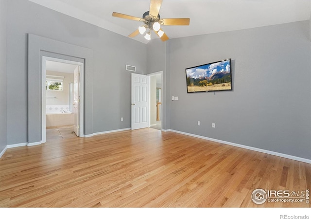 10216 Sandy Ridge Ct, Firestone, CO 80504 - unfurnished bedroom with light wood-style flooring, ensuite bath, lofted ceiling, and ceiling fan